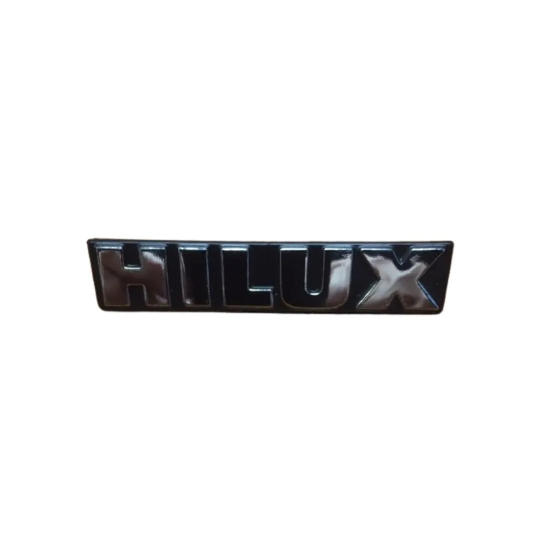 EMBLEMA GUARADABARRO TOYOTA HILUX 85